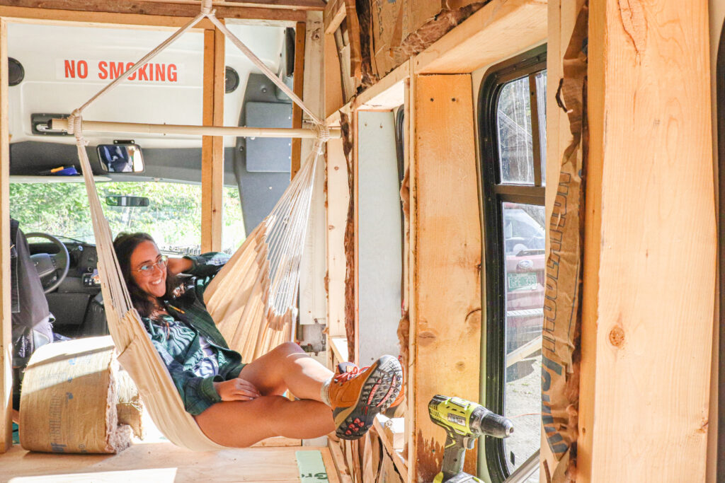 Alia sitting in her half-build shuttle bus for vanlife. This is part of her Adventurepreneur origin story.